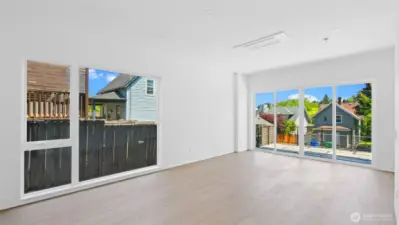 Living Room With Large Window & Ample Natural Light + Ductless Minisplit