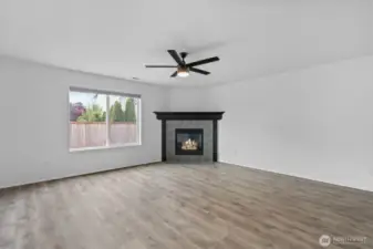 Tile wraps the gas fireplace with wooden mantle, providing winter warmth and bringing ambiance to the room.