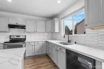 Stunning quartz counters and full tile back splash. Farmhouse sink with gooseneck faucet.