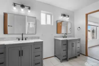 His and her vanities in private Primary bathroom.