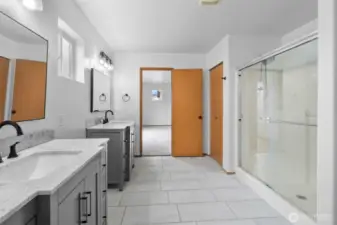 Walk-in shower with glass door.