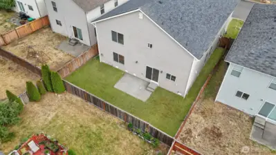 Enjoy the outdoors in fully fenced yard with patio, perfect for grilling. Grass has been digitally edited for photos.