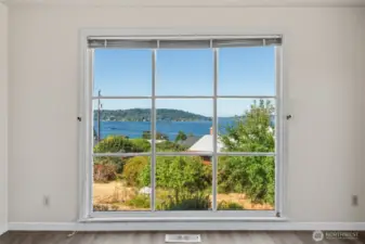 Welcome home—floor-to-ceiling windows in the living room frame Lake Washington in all its glory, offering an ever-changing panorama of natural beauty right from the moment you walk in.