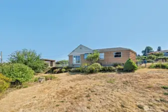 Elevated from the street, this home takes full advantage of its hillside setting, offering open views and endless opportunity for transformation.