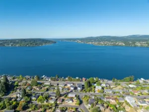 The aerial view showcases the property’s prime location, nestled among charming homes and tree-lined streets in a picturesque neighborhood setting.