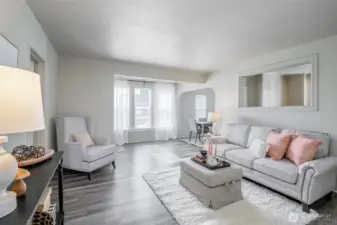Pretty light streams in through the large windows, making this living room a perfect place for your morning coffee.