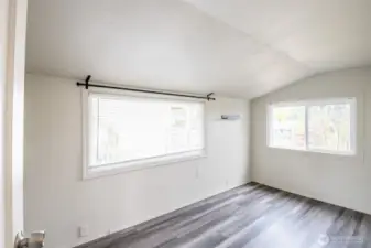 Enjoy this bright bedroom with two large windows.