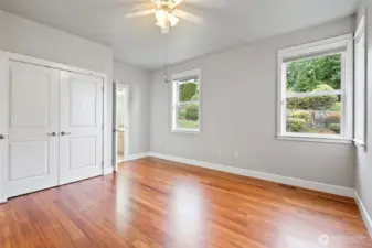 Second guest room. Newly refinished hardwood floors extend throughout the guest area, hallways, kitchen, dining area, primary suite, foyer, and office.
