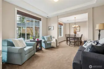 Just off the entry the formal living room offers a refined space for quiet conversation or welcoming guests. Large windows bring in natural light.