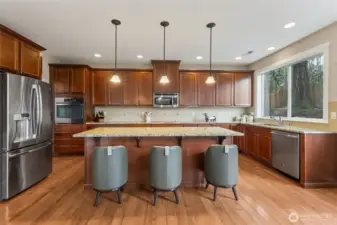 The chef’s kitchen features an oversized island with ample seating for casual meals or entertaining. It’s both functional and stylish for everyday use.