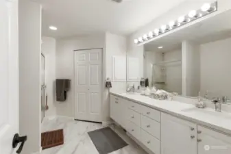 Huge primary ensuite bath with quartz counters, tile floor, & walk-in closet.