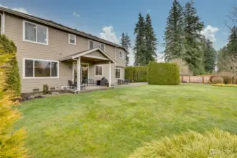 View of back of house and patios from rear fenceline.