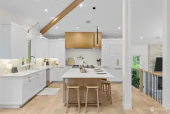 Dream kitchen w/quartz counters, eating island, white rift oak cabinets, & Sonos sound system.