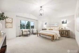 Elegant primary suite with vaulted ceilings and expansive windows. Photos are of the Magnolia model home at Maywood Heights on lot 8. Photos are for illustration purposes only; colors and finishes will vary.
