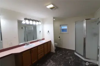 Double sink vanities and a make up area with storage and spacious area.