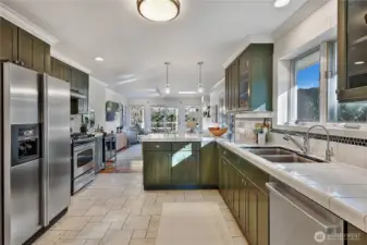 Open kitchen features abundant storage and countertop space and breakfast bar