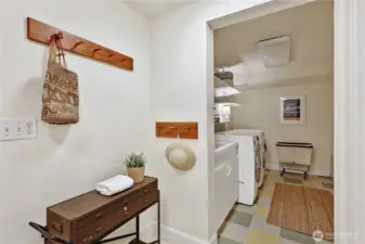 Lower level laundry area with utility sink and garage access