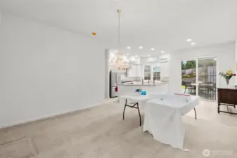 Photo of Great room with Kitchen off in distance and kitchen eating nook on the right.