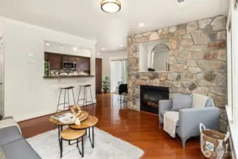 Open Floor Concept Featuring Hardwood Floors and a Stunning Stone Fireplace.