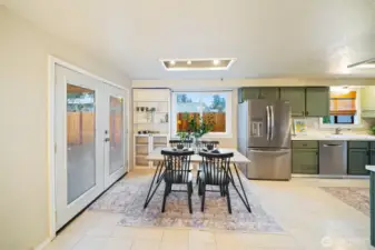 Light and bright kitchen|dining area with recessed lighting.