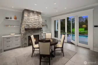 It is hard to know where to look...golf course, beautiful pool or stunning fireplace.  No need to choose, just enjoy it all! Notice the large format tile on the floor to keep indoor outdoor living easy breezy. Every detail of this design was truly thought of to deliver the highest enjoyment and ease you will find.