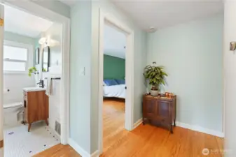 The hallway between living room and bedroom leads into the renovated main floor bathroom