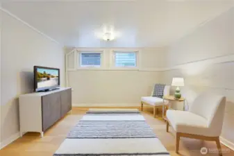 Enormous lower level bedroom with sitting area has high ceilings.