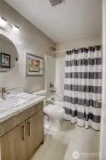 2nd bathroom with bathtub and matching countertops that are featured throughout the home