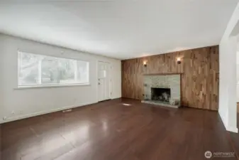 Beautifully updated living room featuring easy-care LVP flooring and a striking wood-burning fireplace. Open-concept layout ideal for family gatherings in this Redmond home located in the highly sought-after Union Hill neighborhood.