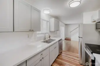 Updated kitchen with quartz counters and stainless steel appliances in this charming 4-bedroom home. Open layout and modern finishes make it a joy to cook and gather in Union Hill, Redmond