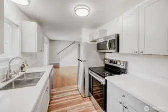 Modern kitchen workspace with elegant quartz counters and stainless steel appliances. A standout feature in this beautifully updated 1,690 sq ft residence with top-rated schools just minutes away in Union Hill.