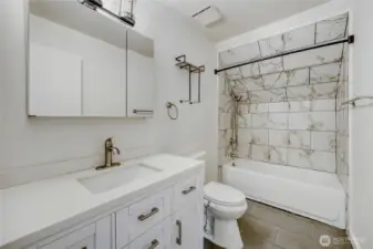 Modern full bathroom featuring quartz counters and a fresh tile surround shower in this updated Union Hill home