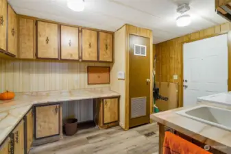 You'll love all the storage in this laundry/utility room with room for an extra fridge or freezer! The furnace is in that closet.