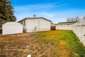 On the right, back side of the house is a large shed.