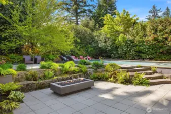 The outdoor spaces are equally well-designed, featuring a stunning pool, multiple patios for entertaining or relaxation, and a detached office/studio that provides both functionality and charm.
