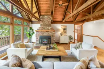 Soaring Vaulted cedar ceilings and a cozy wood-burning fireplace crate a warm, inviting living space