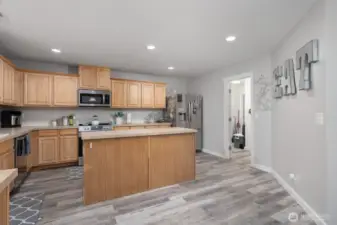 Another view of the kitchen island showcases its large surface—ideal for food prep, homework, or casual meals.