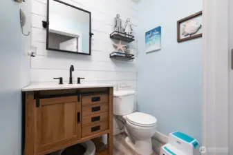 An inviting half bath on the main level features upgraded finishes and is perfectly positioned for guests.