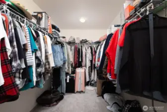 The spacious walk-in closet in the primary suite provides ample storage and organization options