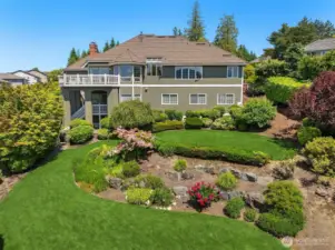 Park-like fully fenced back yard with mature landscaping.