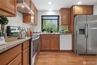 The refreshed Kitchen features oak cabinets, and quartz counter tops.