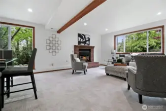 Enjoy the spacious lower-level family room, perfect for entertaining or unwinding by the gas fireplace. A sliding glass door provides seamless access to the inviting side yard deck.