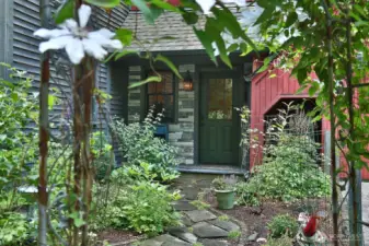 Welcome! A covered front porch entry greets you. All period lighting is special ordered and hand made. All cedar siding has been stained. All interior and exterior wood doors are custom made. Let's go inside......