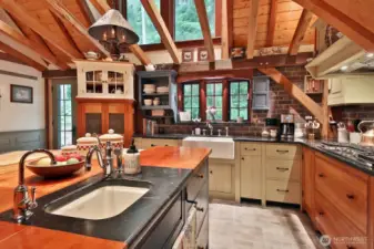Countertops are Soapstone. Kitchen Aid appliances have custom exterior panels. Kohler prep sink and DXV 30" Farm Sink. Brick pattern tile.