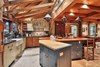 Custom center island w/ Cherry tabletop and Maple butcher block bake station with a heavy appliance lift. All cabinets are custom made with solid wood, drawers are dovetailed soft closing. Blue cabinet milk paint with glaze.