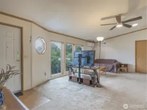 Bright and airy living room features vaulted ceilings and expansive windows that flood the space with natural light throughout the day
