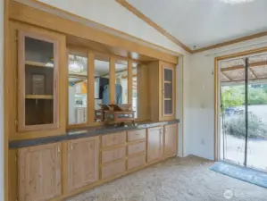 The dining area features built-in cabinets for convenient storage and display, adding both charm and practicality to the space.
