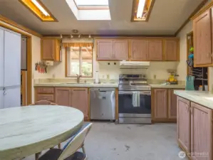 This thoughtfully designed kitchen features a built-in table that creates a cozy, casual dining nook — perfect for everyday meals or morning coffee.