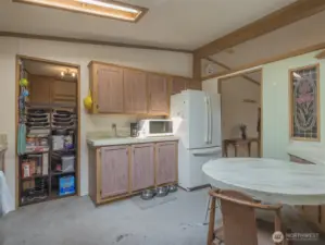 Surrounding cabinetry offers generous storage, with upper and lower cabinets providing space for cookware, pantry items, and small appliances.
