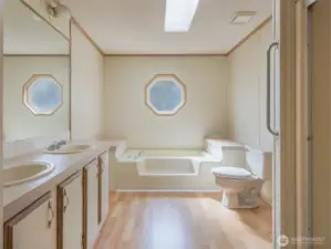 The en-suite bathroom features a deep soaking tub perfect for unwinding, a separate shower.